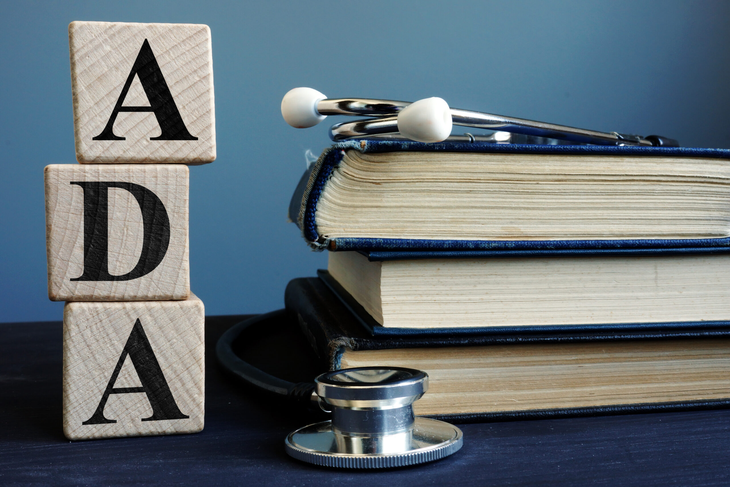 Word ADA Americans with Disabilities Act from cubes and books.